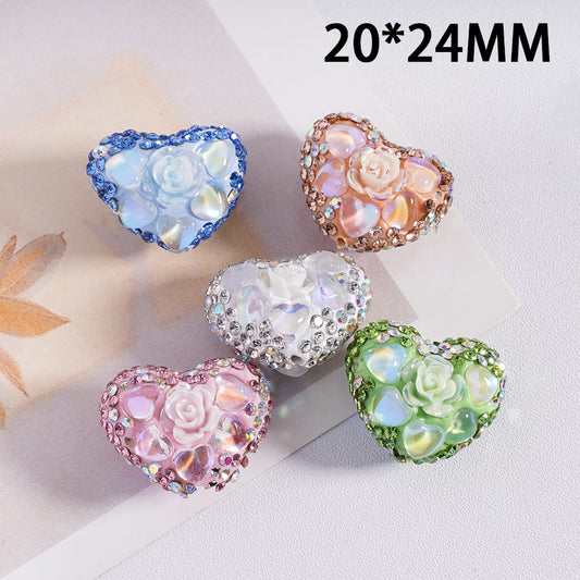 Heart-shaped decorative stones with floral designs on a light background