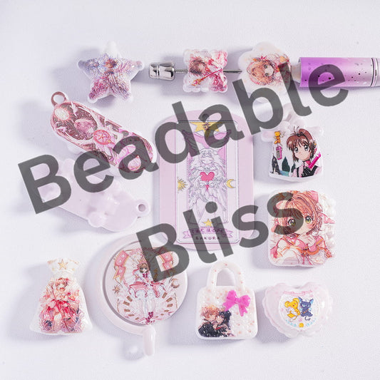 Collection of small decorative items with anime characters on a white background, featuring the brand 'handsontupply'.com'.