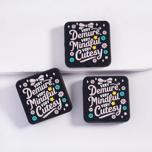 Three black square patches with white text and decorative elements on a white background