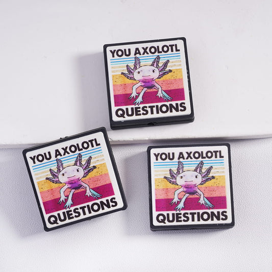 Three 'You Axolotl Questions' patches on a white background
