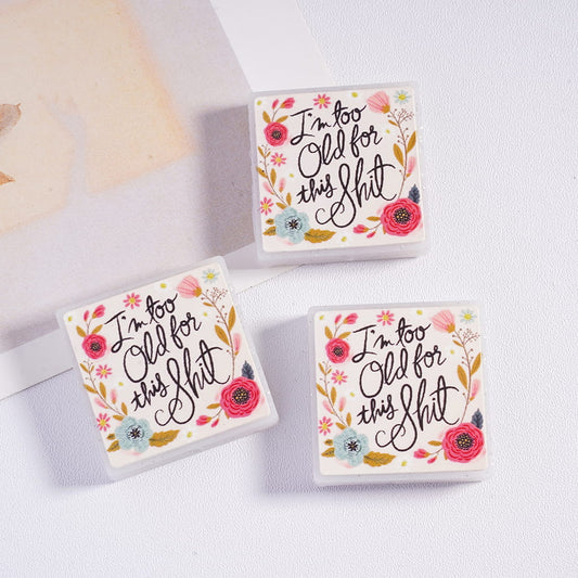 Three small boxes with floral designs and text on a light background