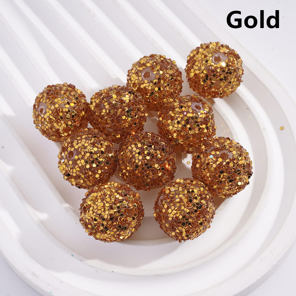 Gold glittery spherical objects on a white background with 'Gold' text.

