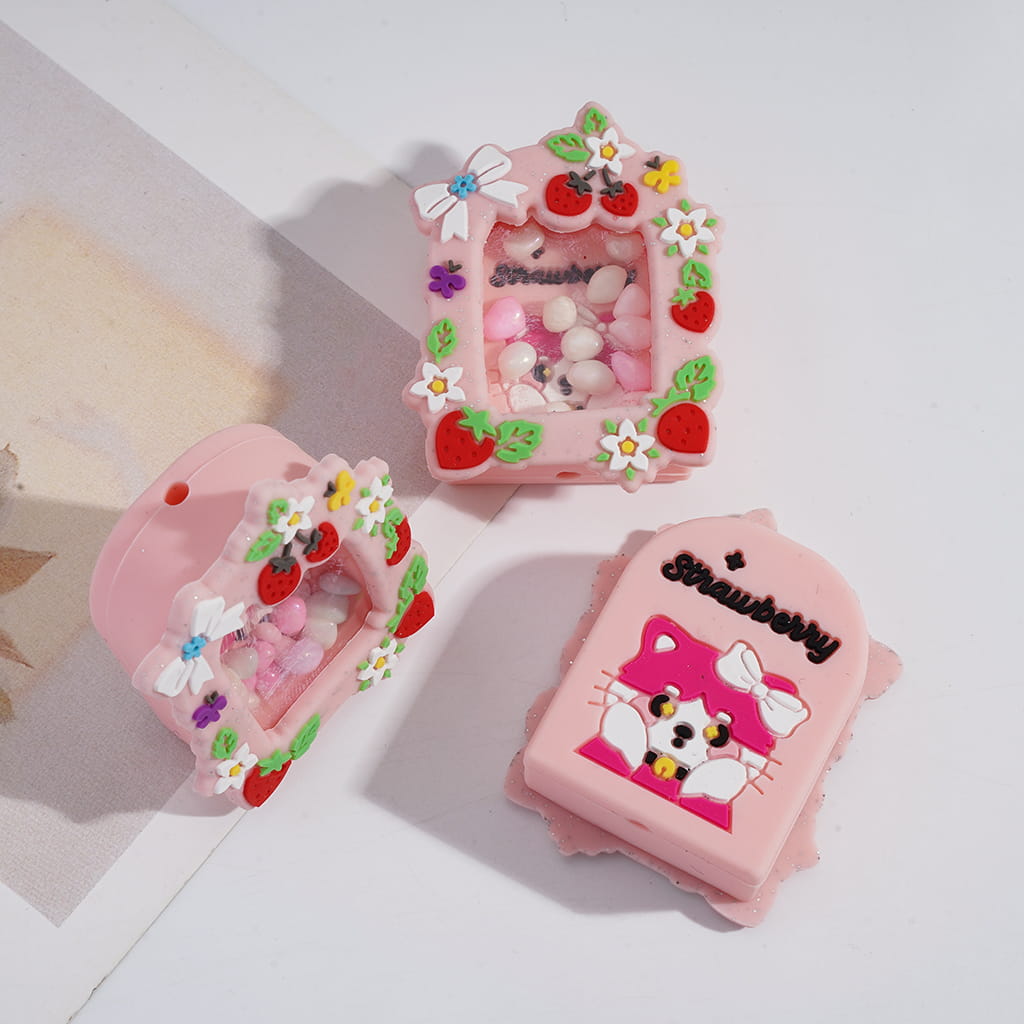 Two pink phone cases with strawberry and cat designs on a white background