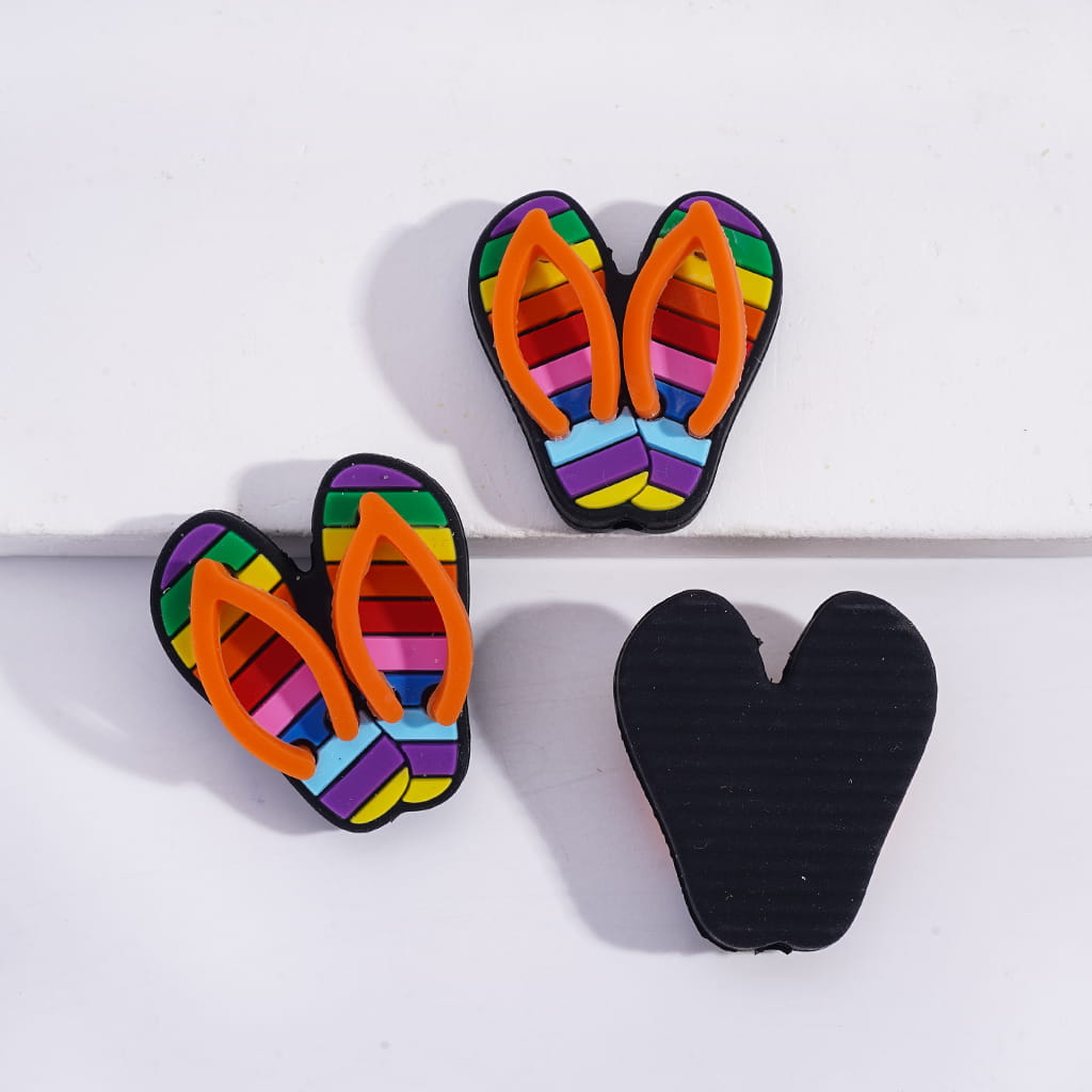 Colorful striped flip-flop earrings on a white background