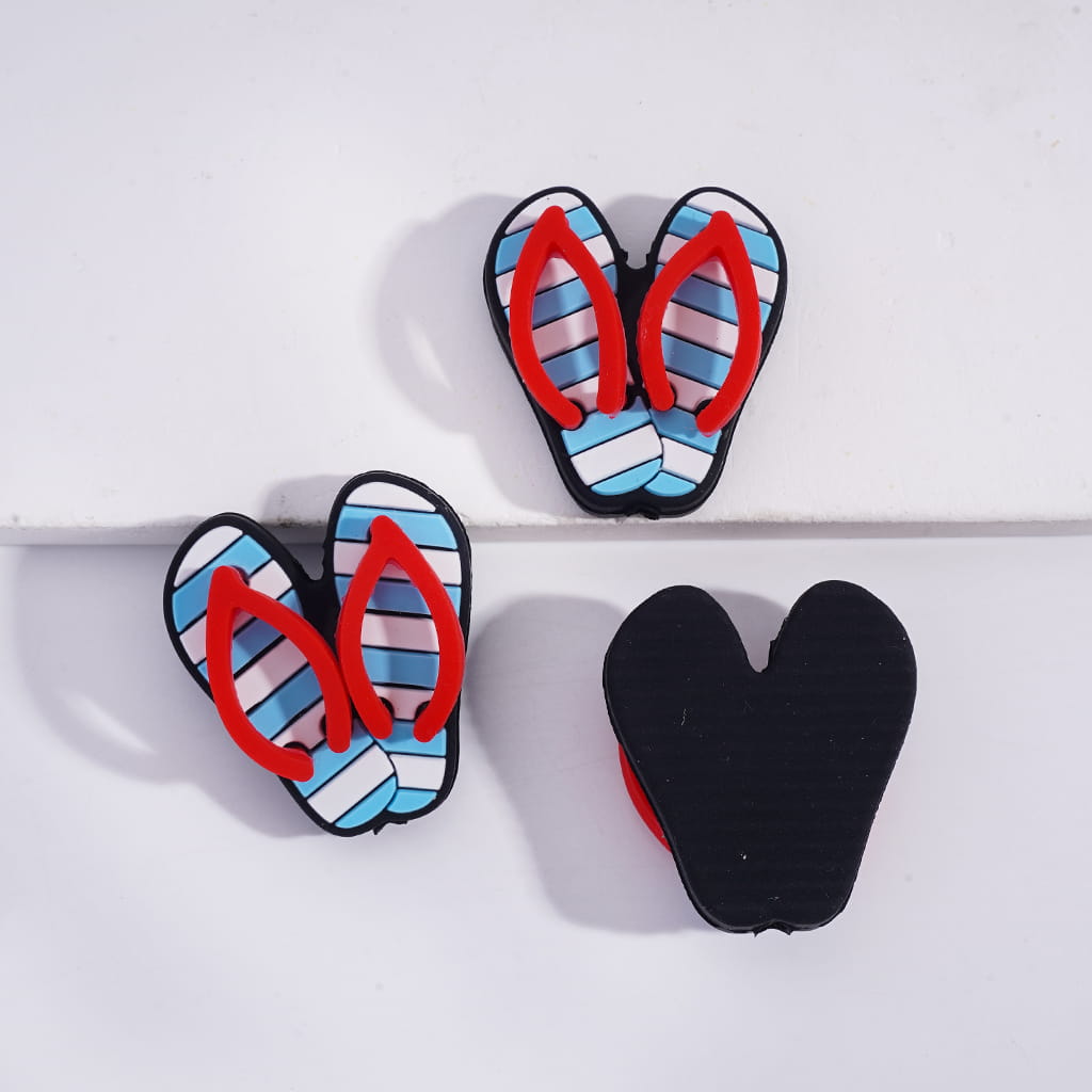 Flip-flop-shaped earrings with striped pattern on a white background