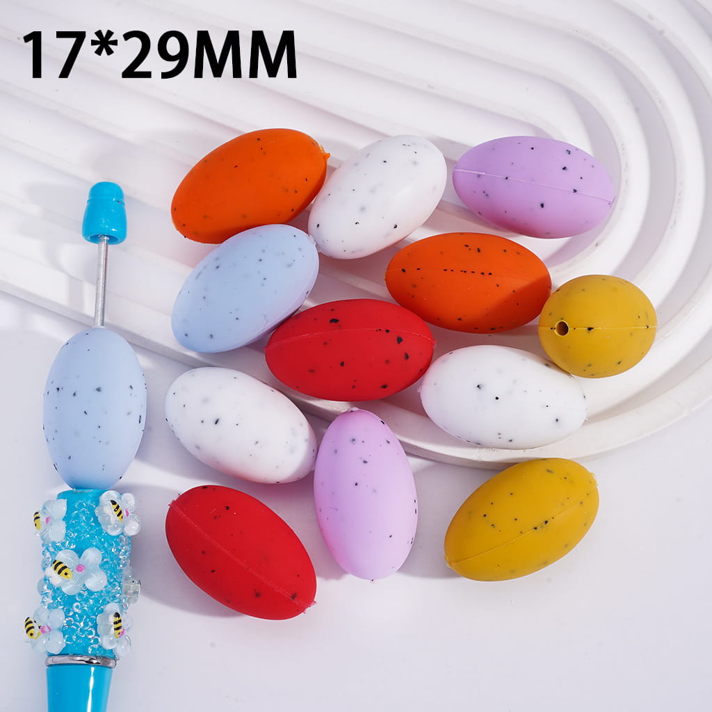 Colorful oval beads with a blue tool on a white background