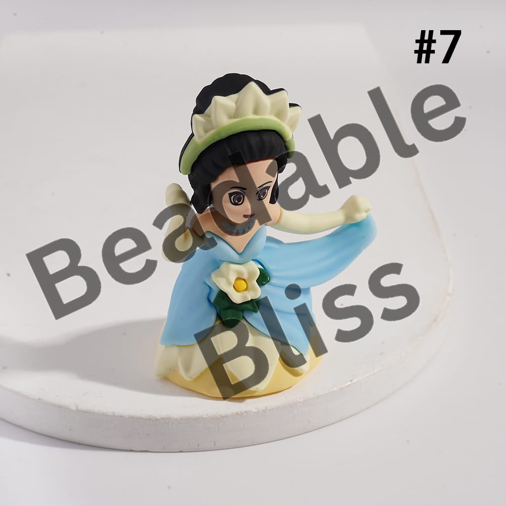 Small figurine of a character with a blue dress and white hat on a white background with 'handsontosupply.com' text.