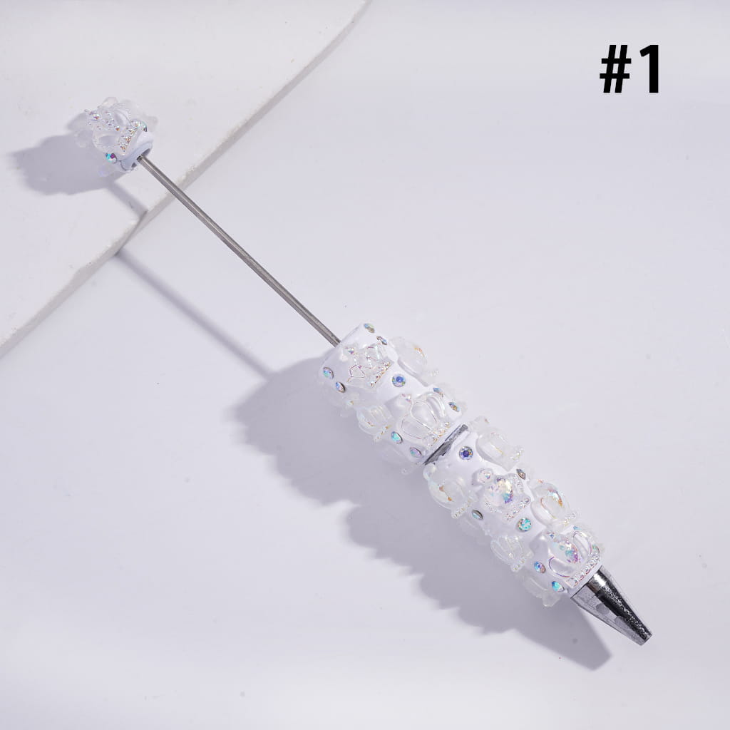 Decorative pen with gemstones on a light gray background