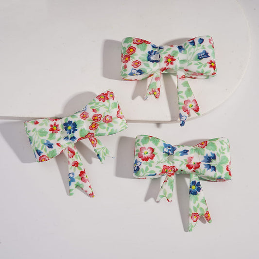 Three floral-patterned bows on a white background