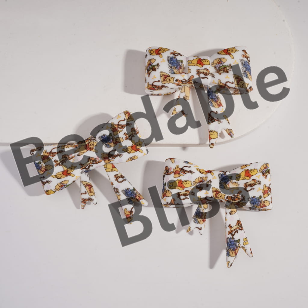 Set of three bow ties with a colorful animal pattern on a white background, branded 'handonsupply'.