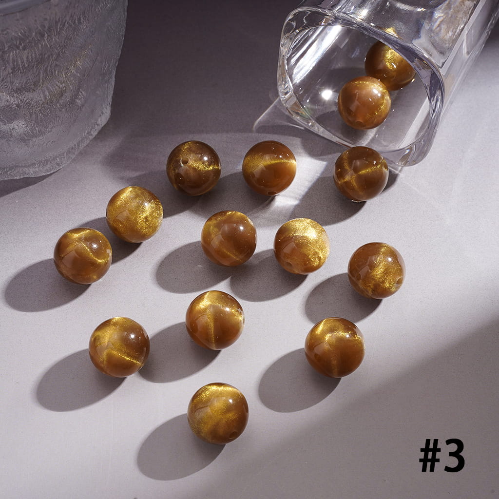 Brown marbled beads on a light surface with a clear container.
