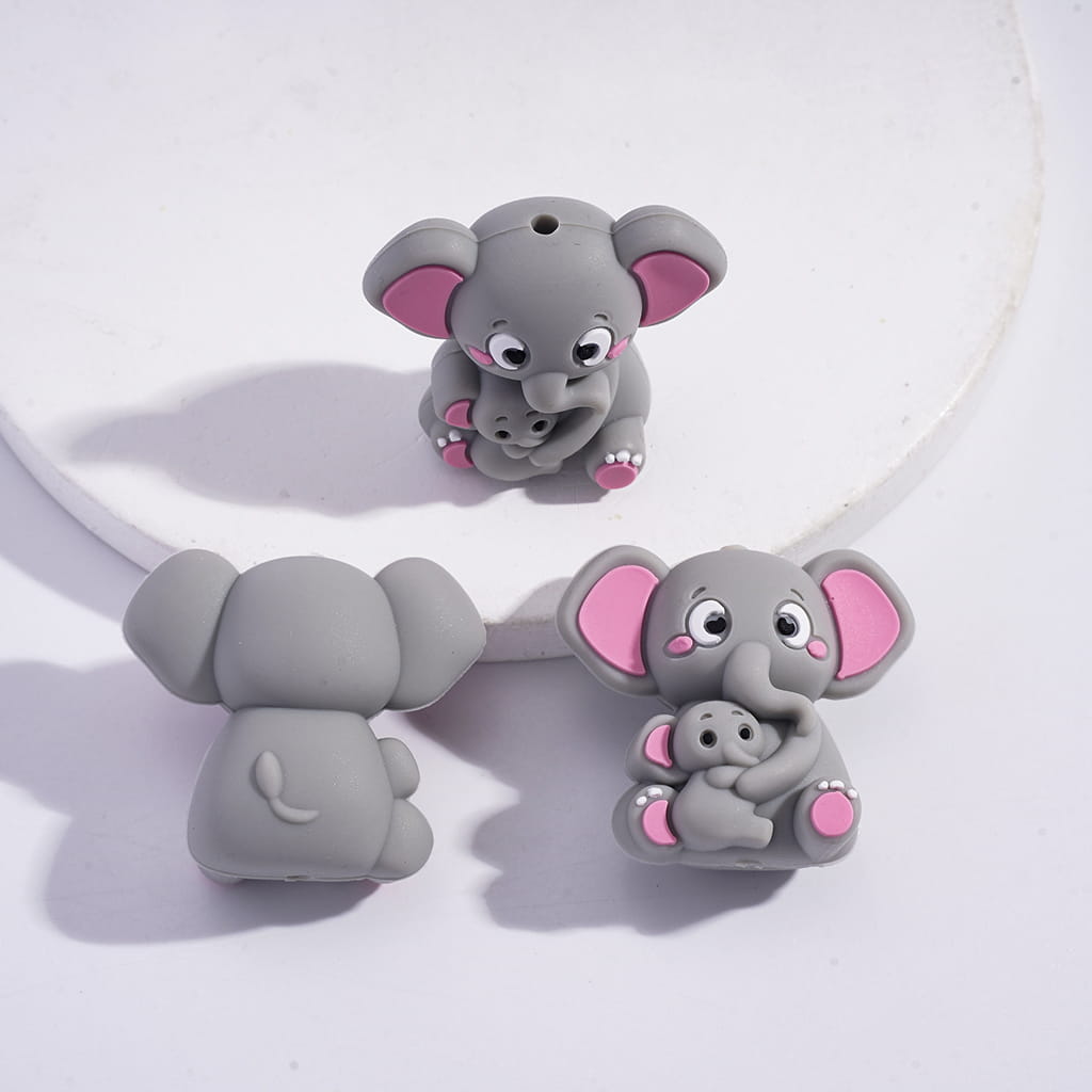 Gray elephant-shaped earrings with pink accents on a white background