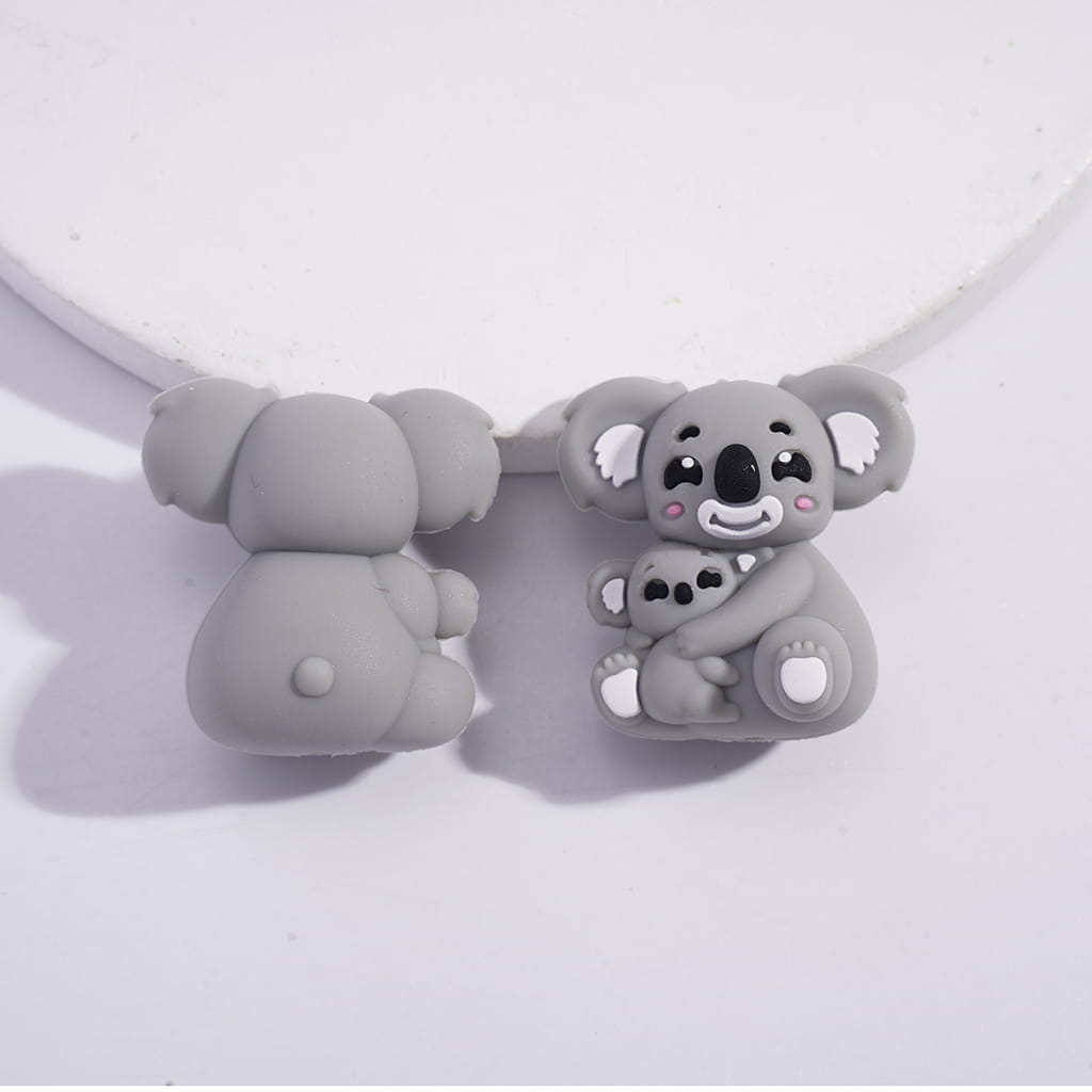 Gray koala-shaped earbud covers on a white background