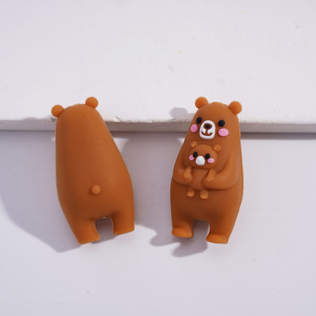 Two brown bear figurines on a white background