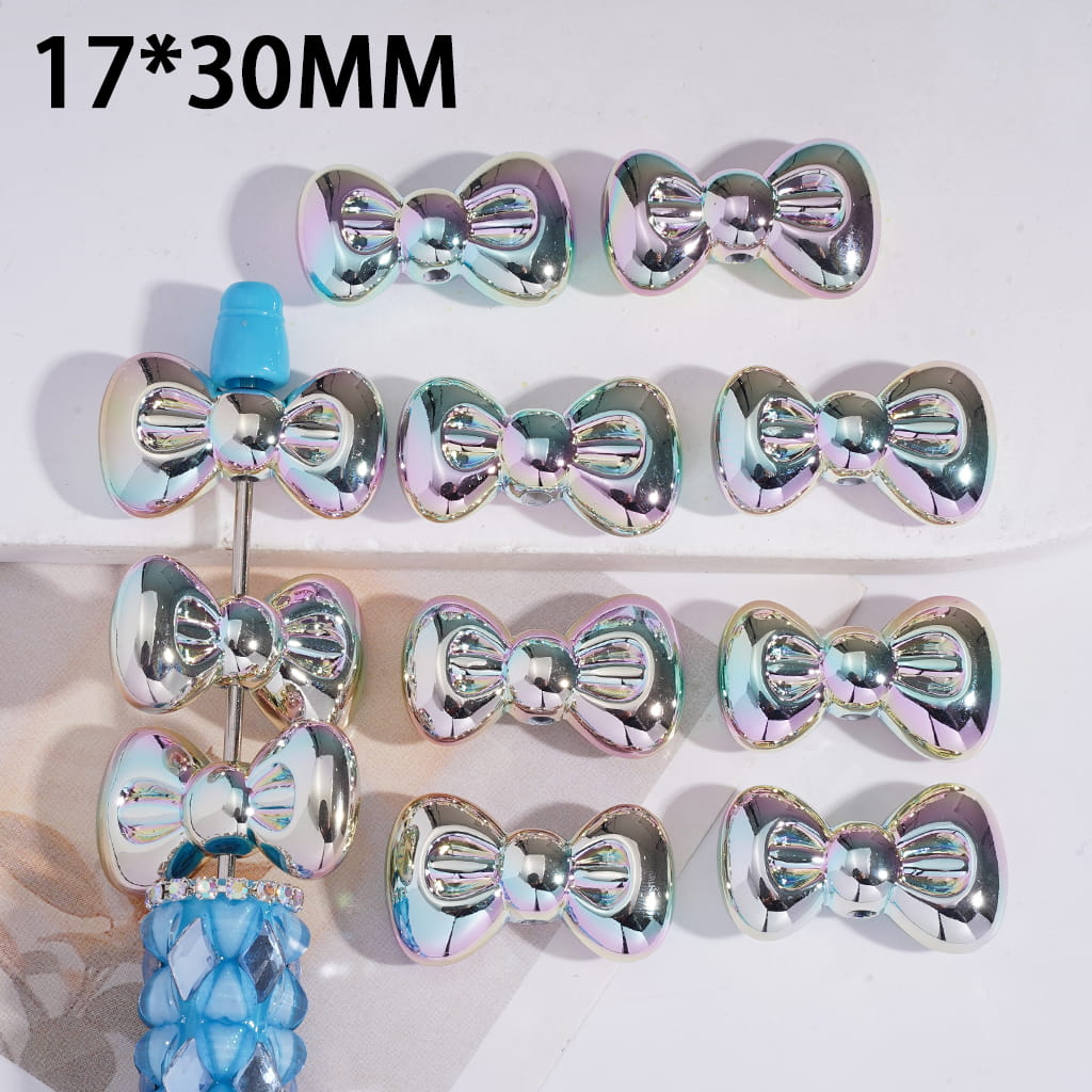 Iridescent bow-shaped objects on a white background with dimensions 17*30MM.
