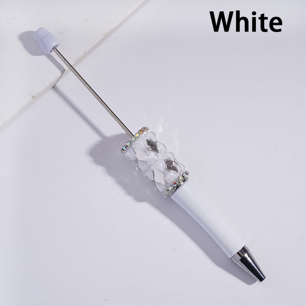 White pen with decorative cap on a light gray background