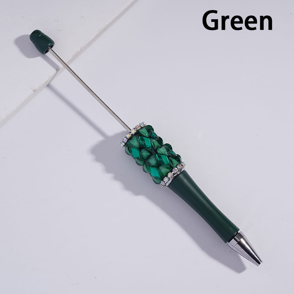 Green pen with decorative beads on a white background