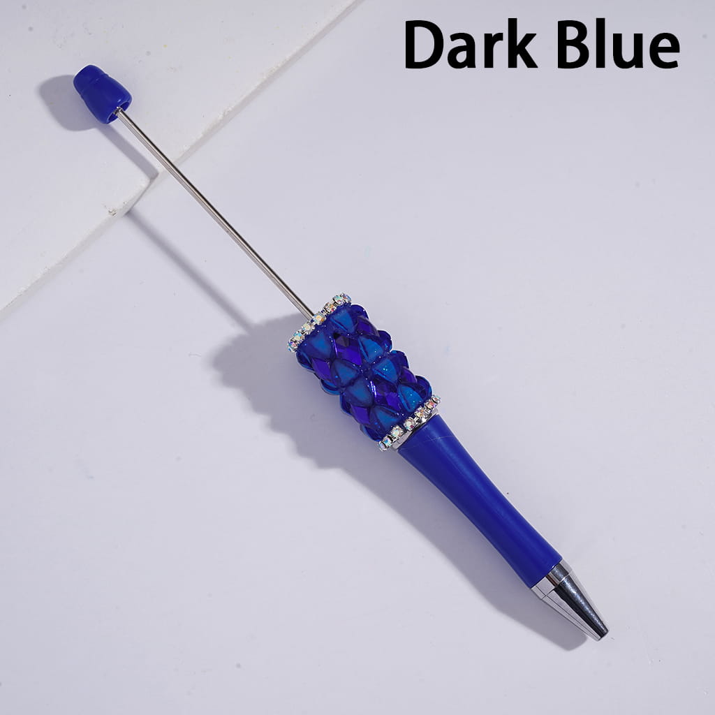 Dark blue pen with decorative elements on a light gray background