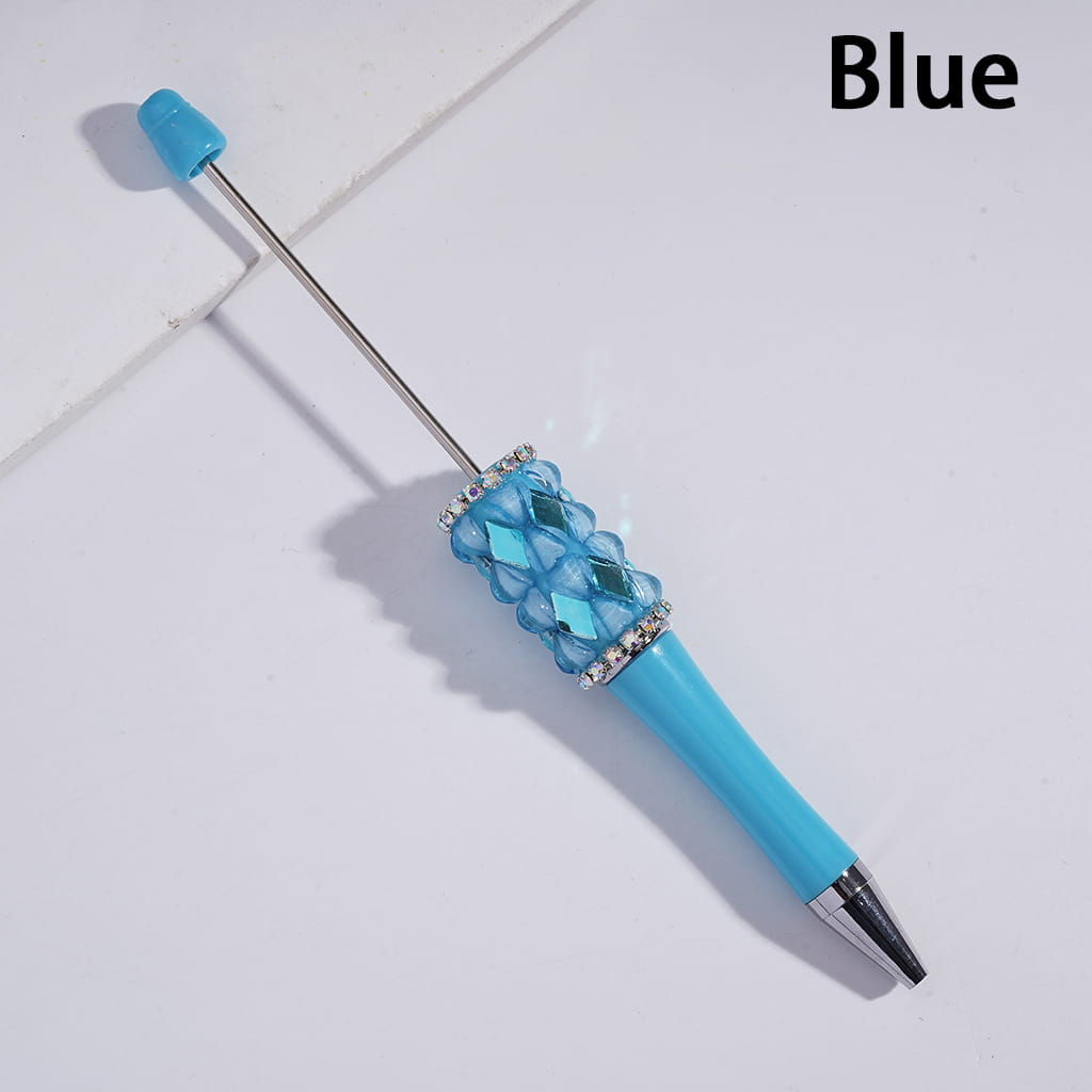 Blue pen with decorative cap on a light gray background