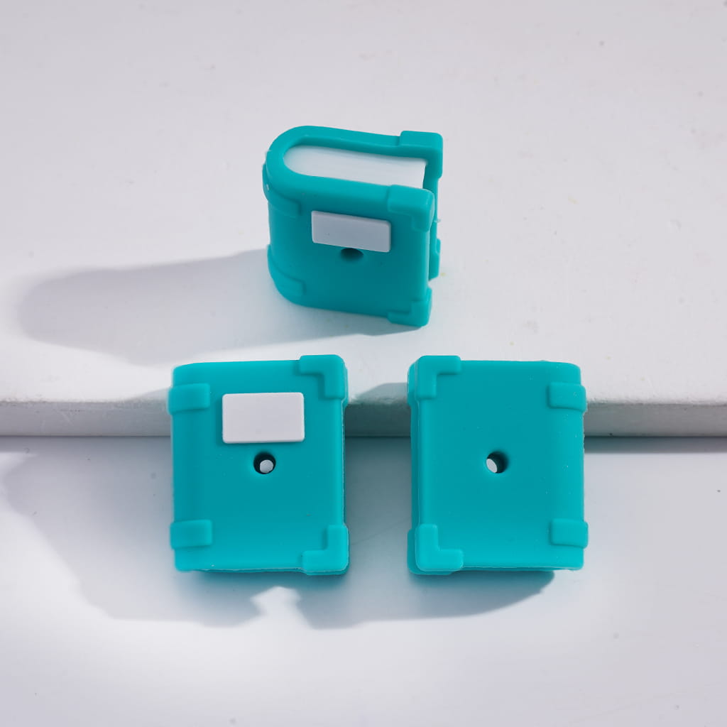 Three turquoise silicone clips on a white background