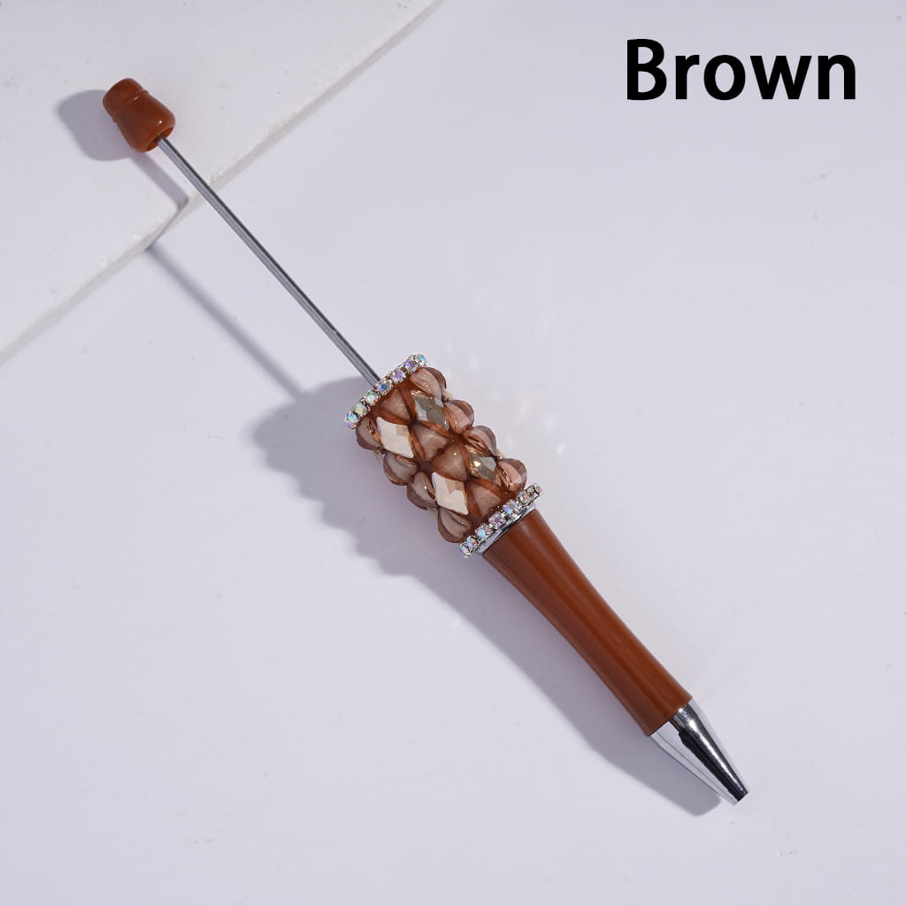 Brown pen with decorative top on a light gray background
