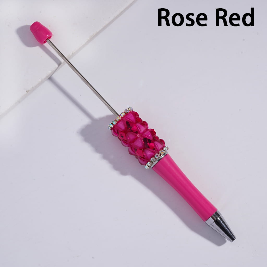 Rose red pen with decorative top on a light background