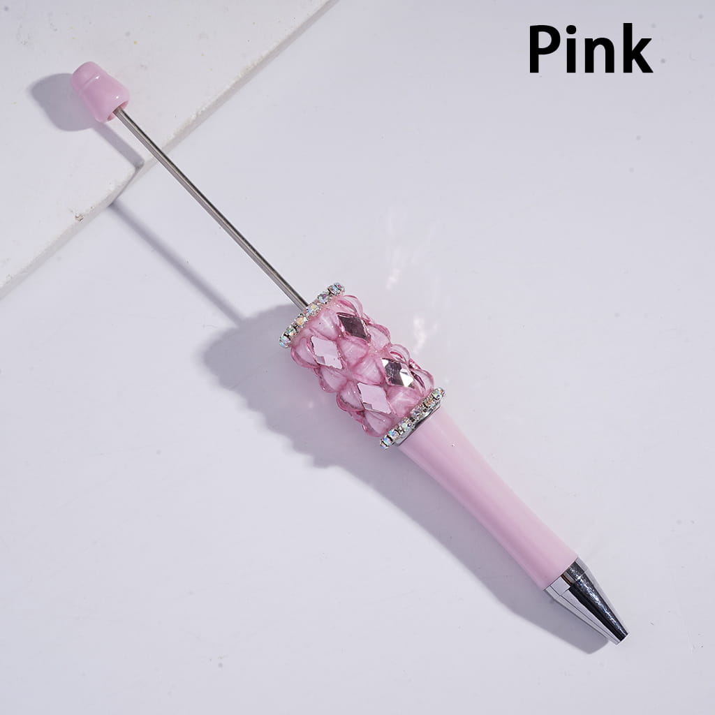 Pink pen with decorative cap on a light background