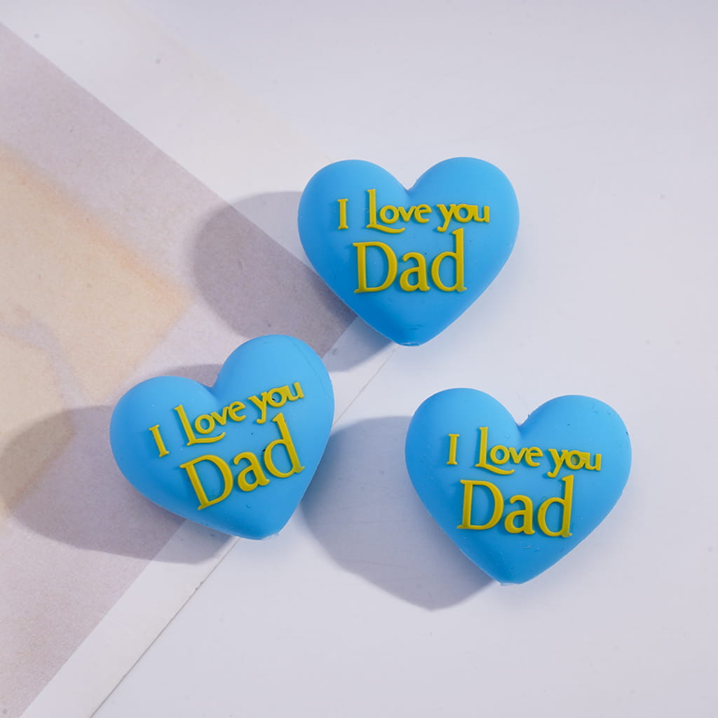 Three blue heart-shaped objects with 'I Love you Dad' text on a light background