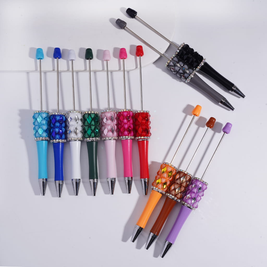 Colorful pens with decorative caps on a white background