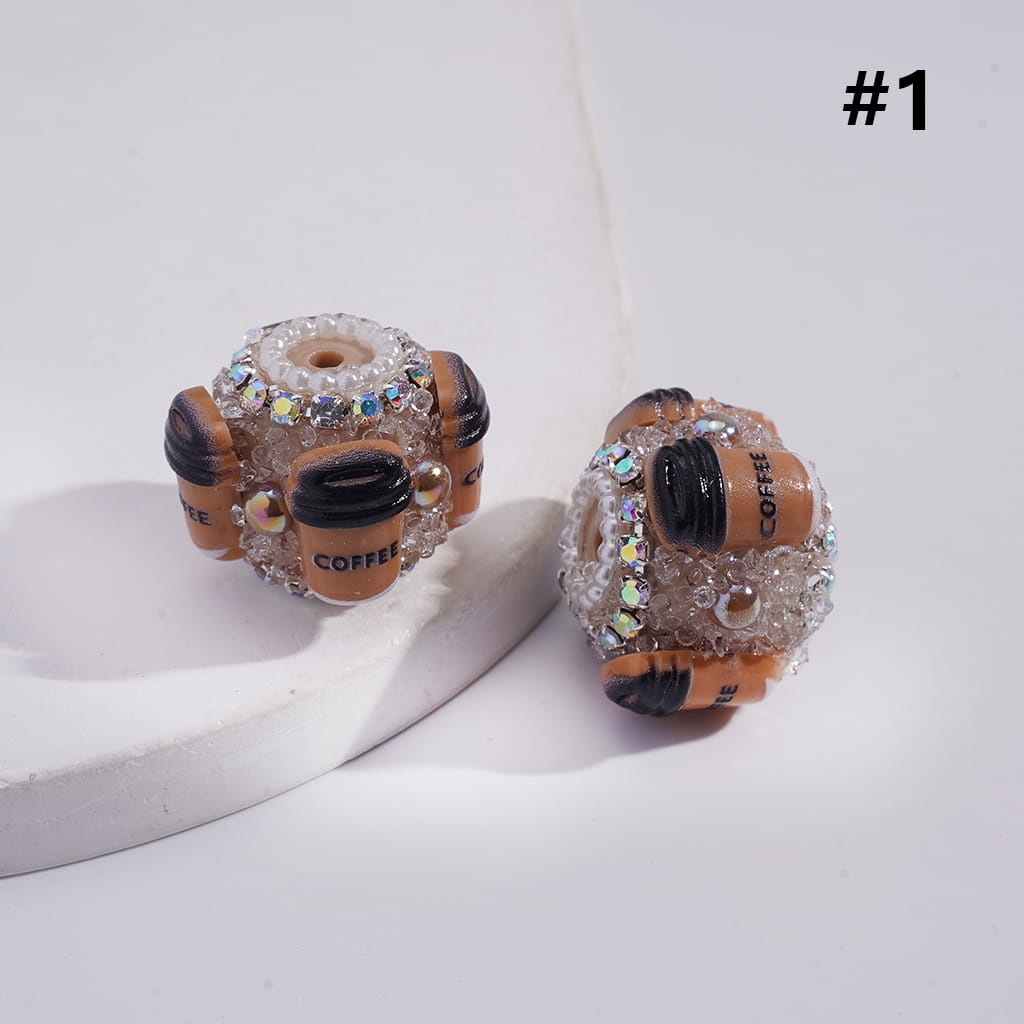 Pair of coffee-themed earrings with decorative elements on a light background