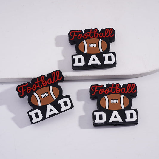 Three 'Football Dad' decorative pins on a white background