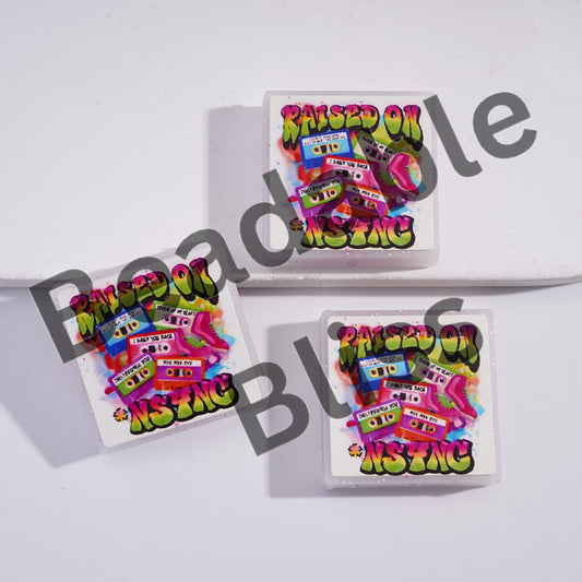 Three colorful playing card decks with 'Raised On Music' text on a white background.