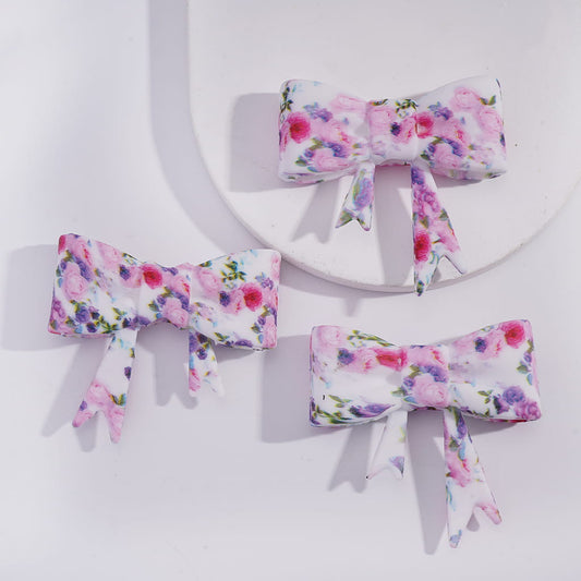 Three floral-patterned bows on a white background