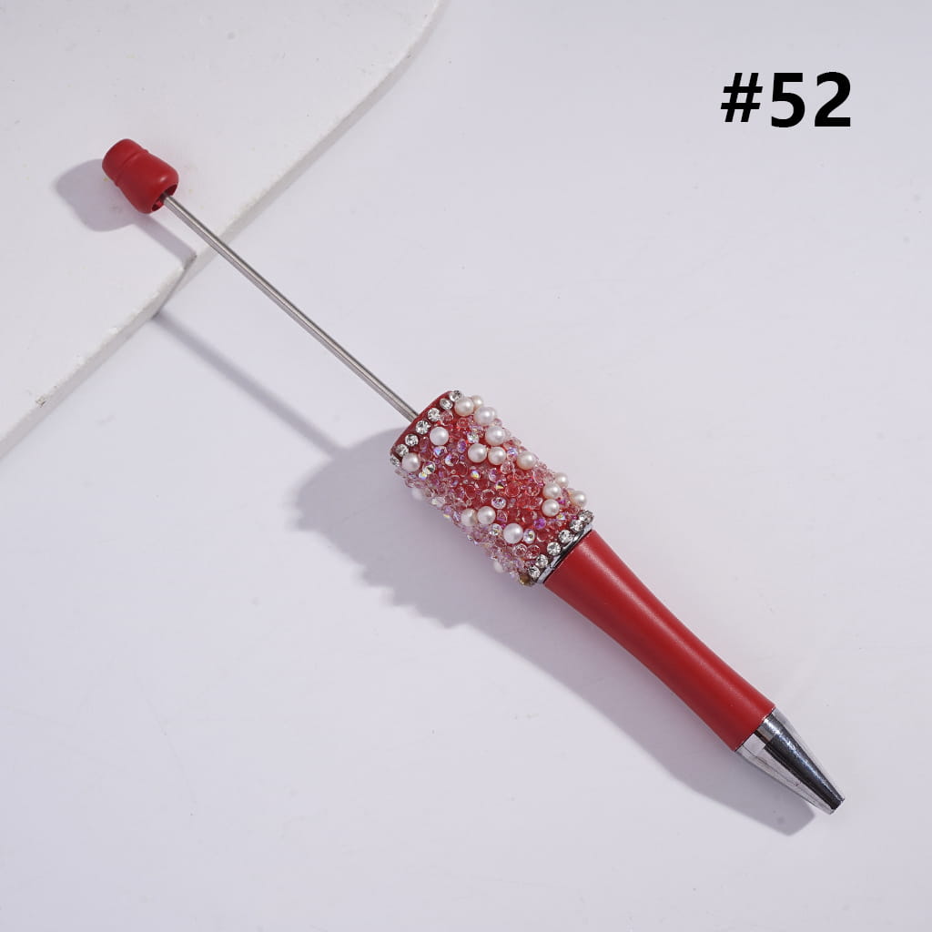 A collection of pens with clear rhinestone chains and colorful beadable tops, labeled with different numbers.

