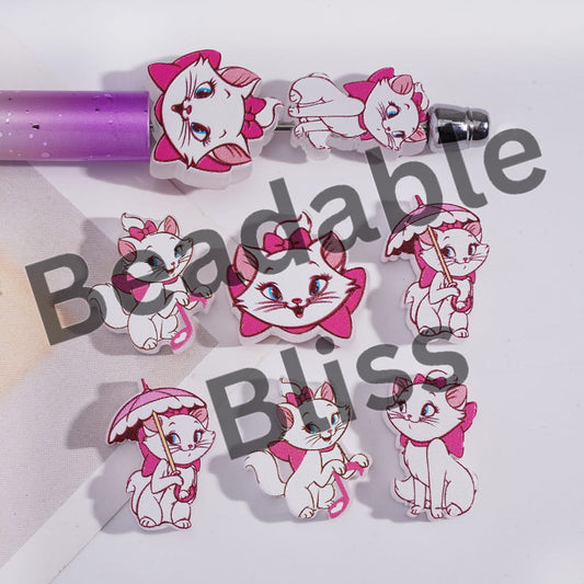 Cartoon cat character earrings with pink bows and umbrellas on a white background with 'Beadable Bliss' text.