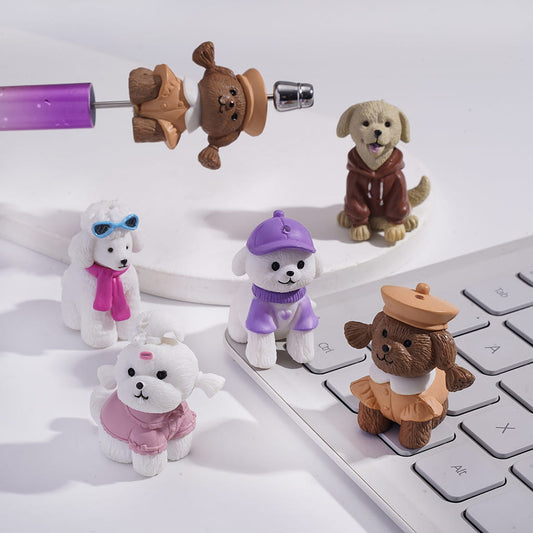 Small dog figurines in various outfits on a keyboard