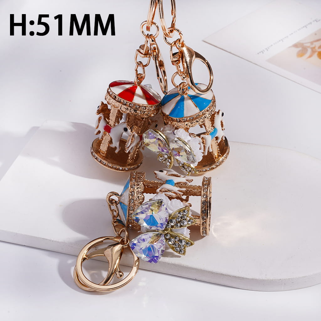 Decorative earrings with carousel and butterfly designs on a white background