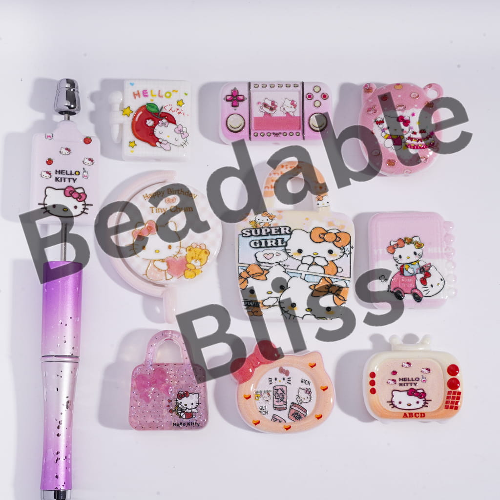 Collection of Hello Kitty-themed stationery items on a white background with 'beadablebliss.com' branding.

