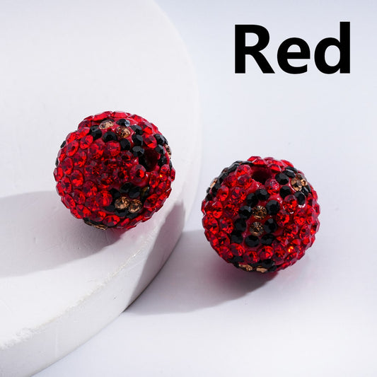 Red and black embellished earrings on a white surface with 'Red' text above.

