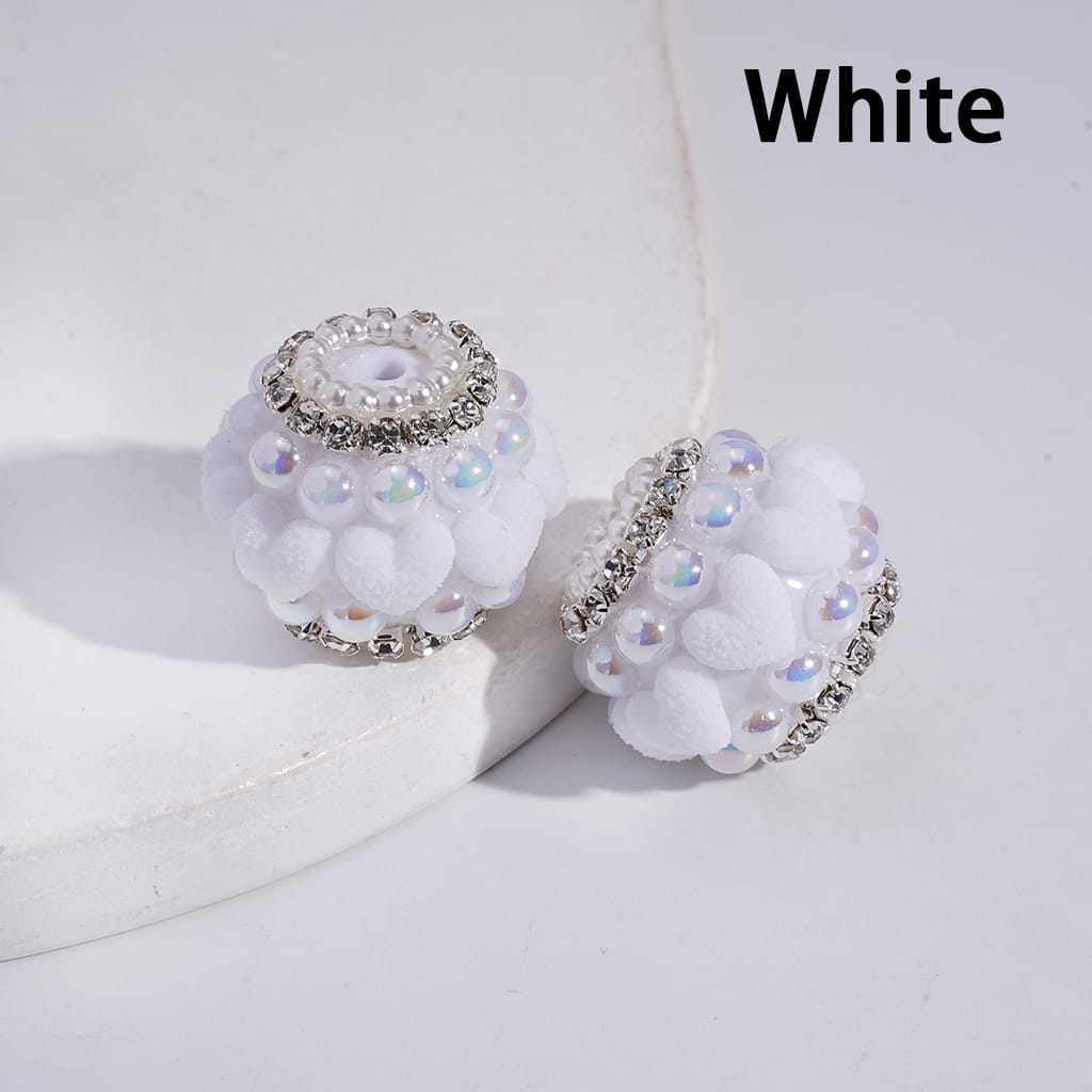 White earrings with rhinestones on a white background