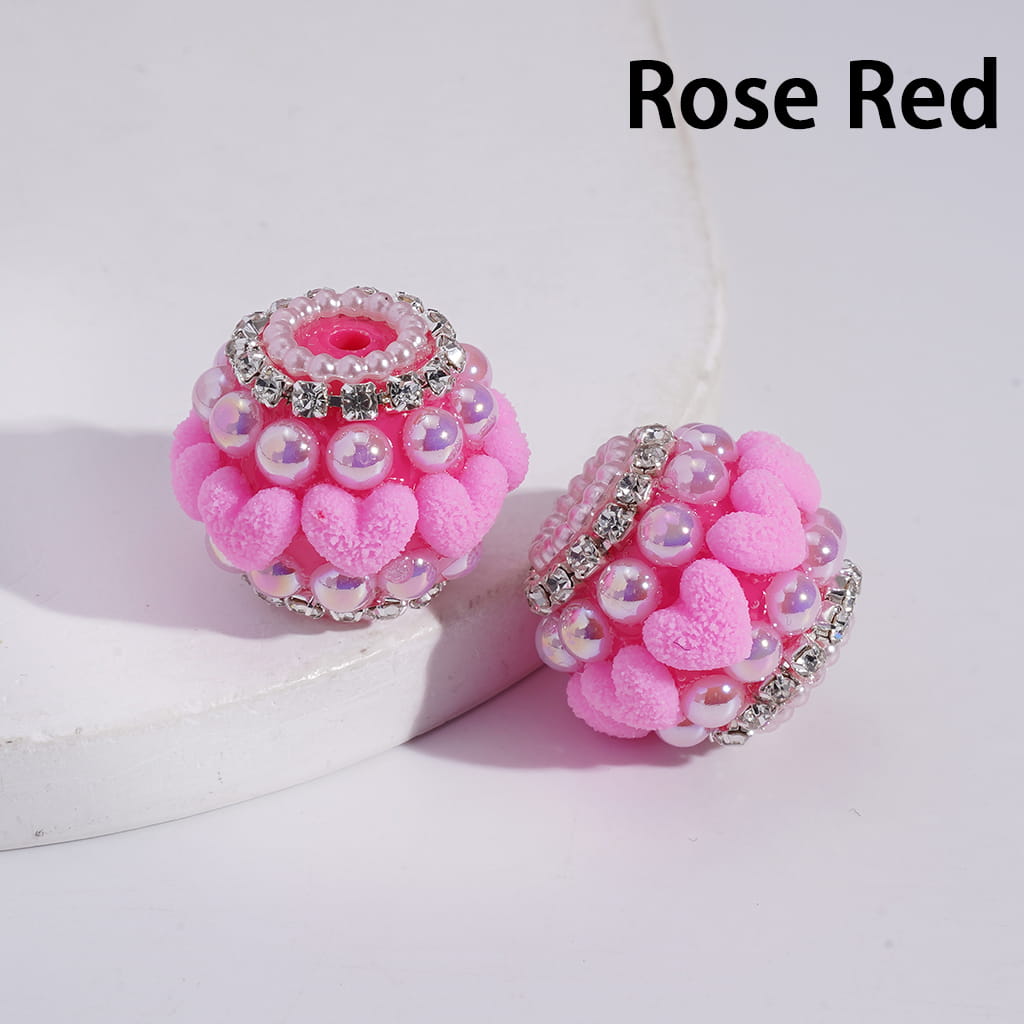 Two pink heart-shaped beads with decorative elements on a white background, labeled 'Rose Red'.