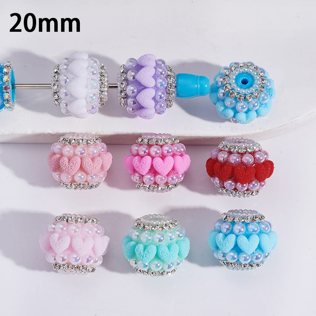 Decorative beads with floral and heart designs on a white background, labeled '20mm'.