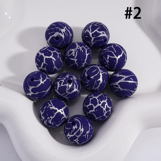 Blue marbled beads on a white surface