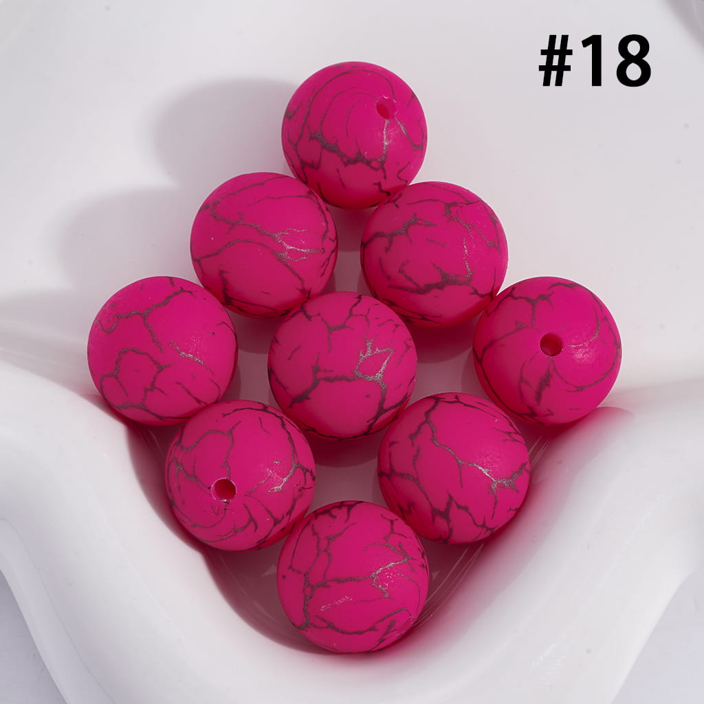 Pink marbled beads on a white background