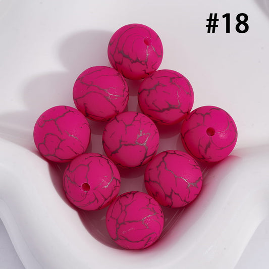 Pink marbled beads on a white background