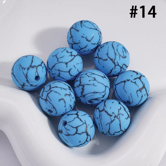 Blue marbled balls on a white surface with a brand number #14.