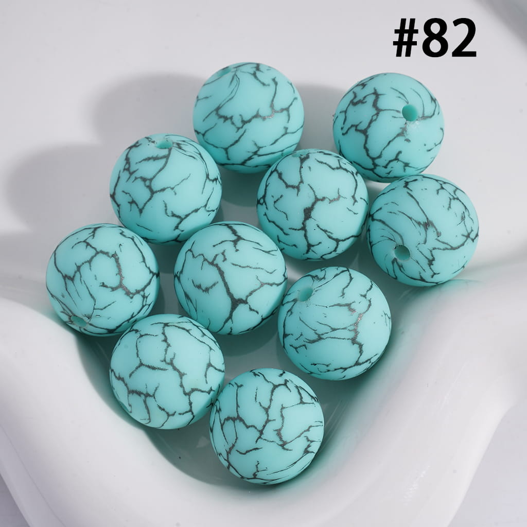 Turquoise beads with a marbled pattern on a white background