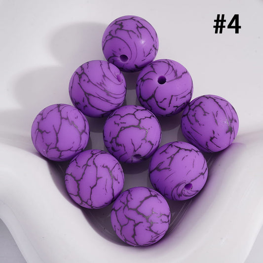 Purple marbled beads on a white background