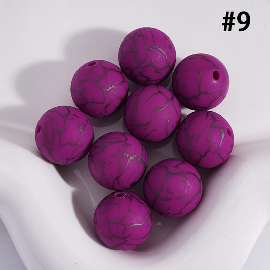Purple marbled beads on a white background
