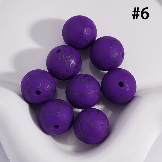 Purple marbled beads on a white background